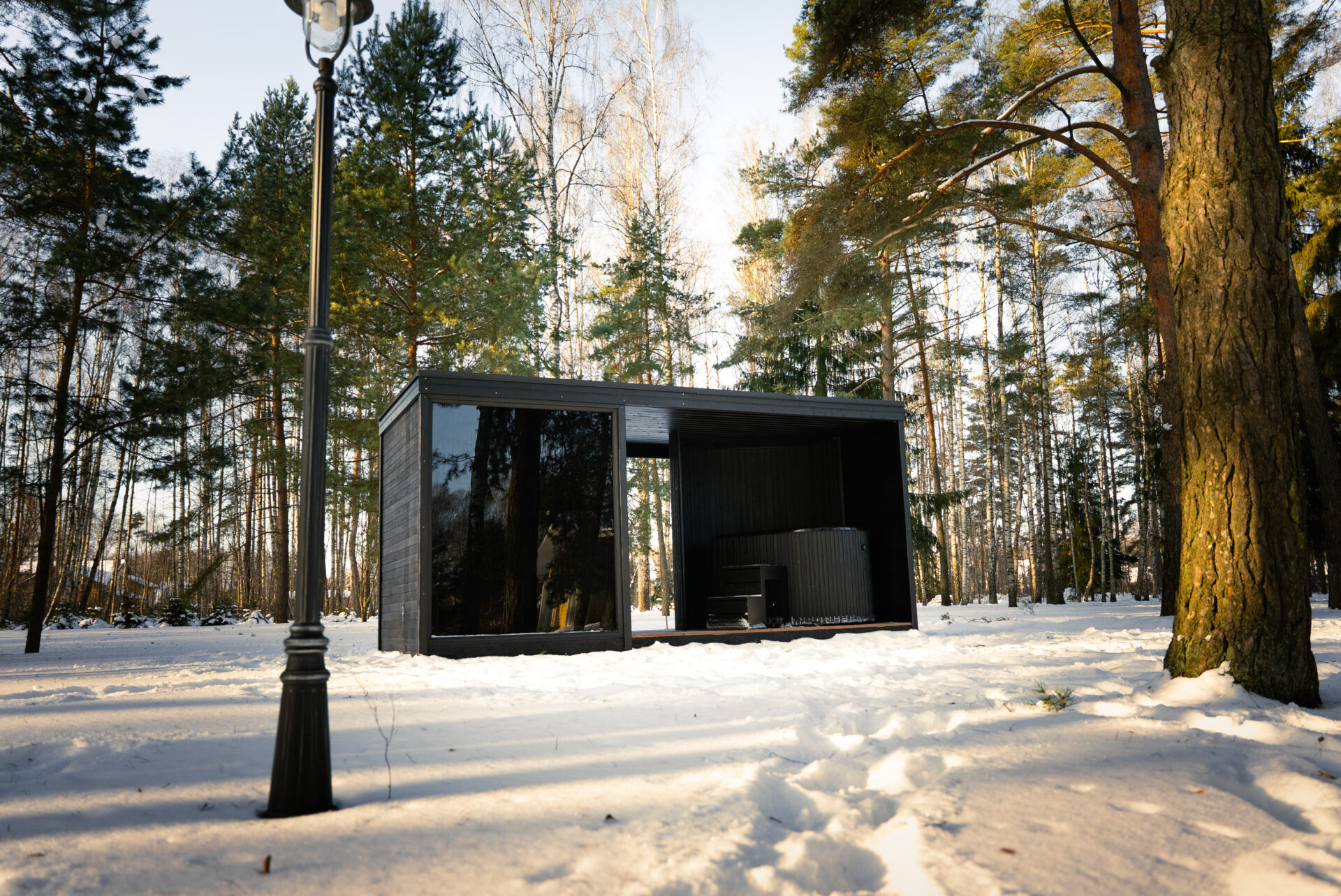 Quite modular sauna resting in a winter forest, designed for slow outdoor wellness