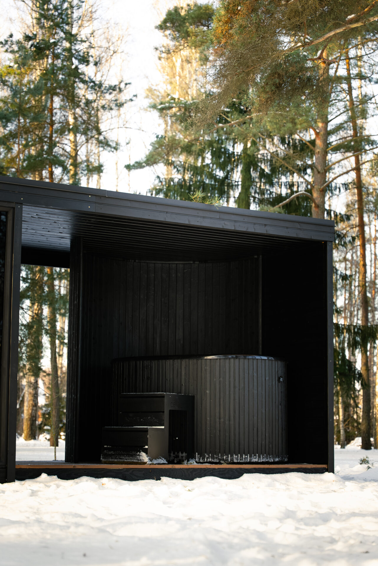 Quite modular sauna resting in a winter forest, designed for slow outdoor wellness