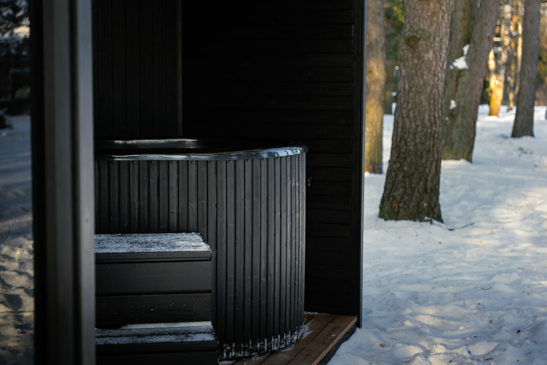Quite modular sauna resting in a winter forest, designed for slow outdoor wellness