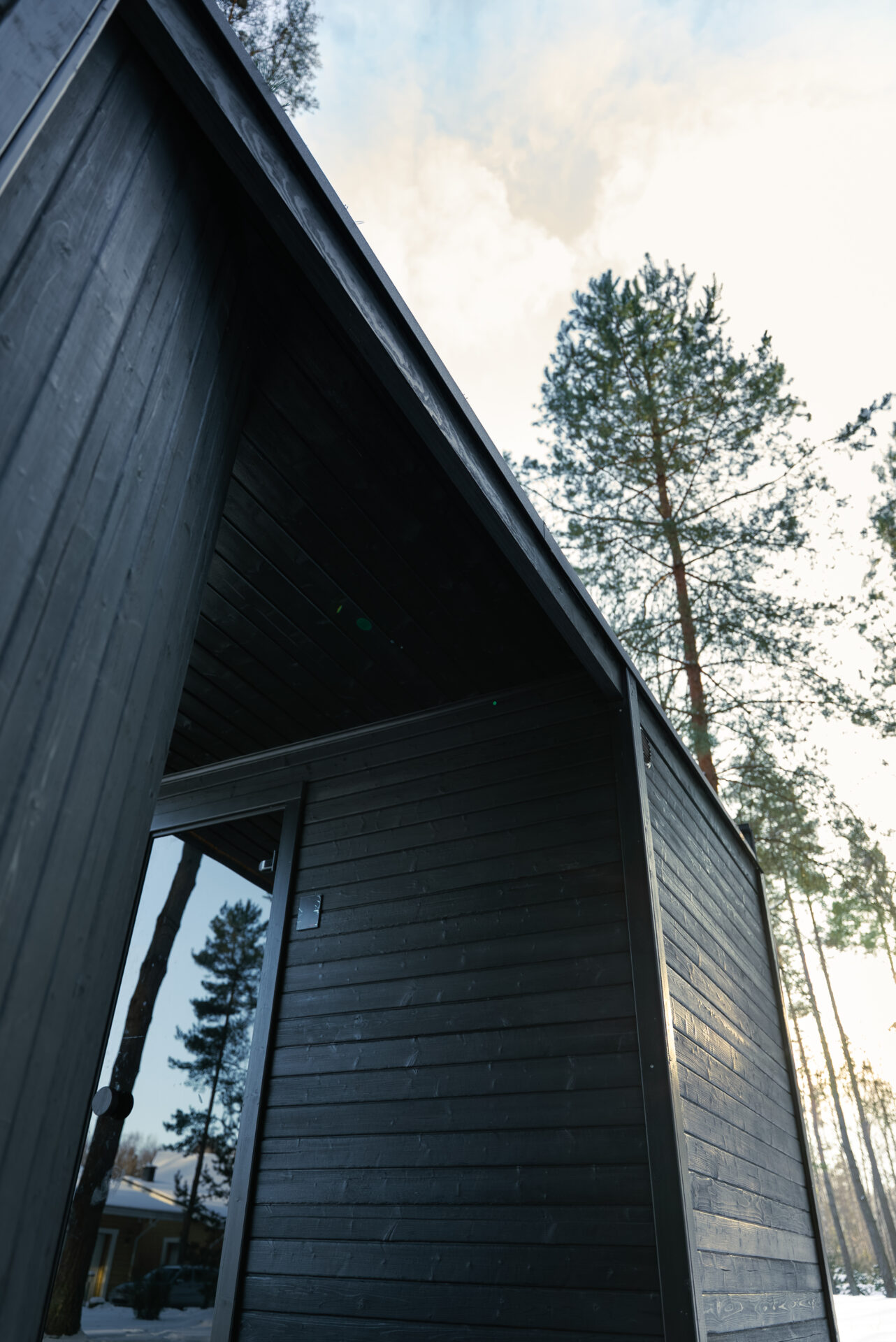 Quite modular sauna resting in a winter forest, designed for slow outdoor wellness